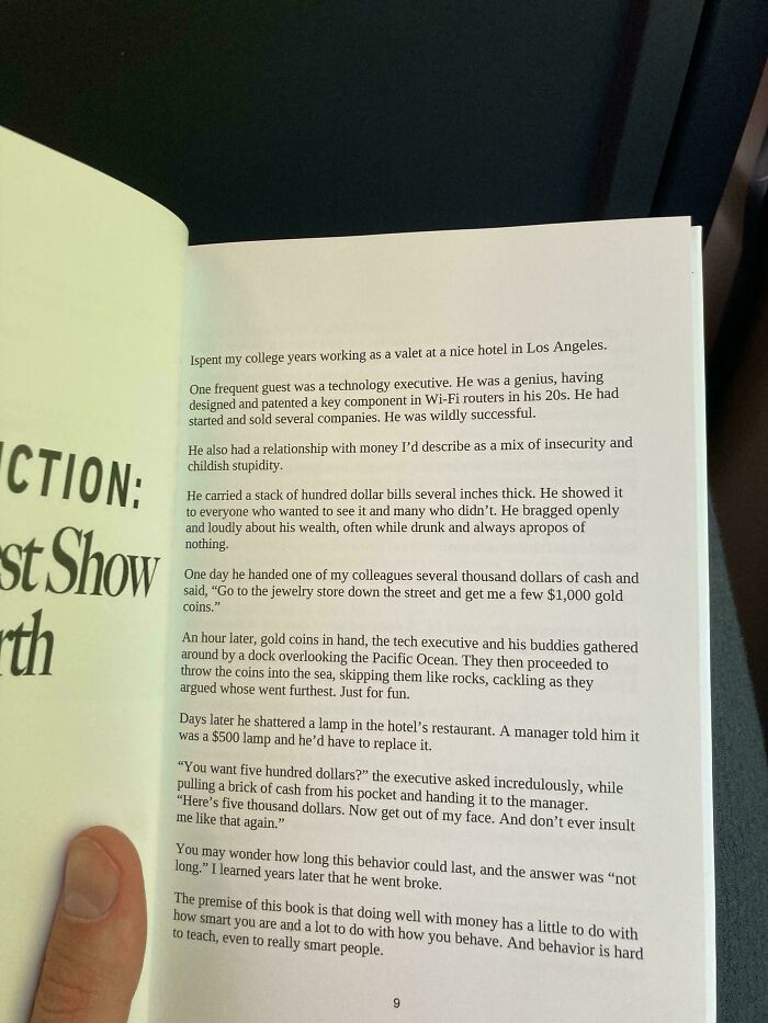 Poorly written text in an open book with a person holding the page, showing an example of design issues in books.