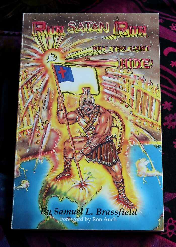 Terrible book cover featuring a warrior holding a flag with a cross, surrounded by fire and lightning.