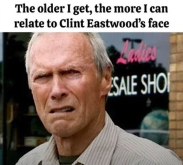 Man outside shop with an expression matching face-related humor, evoking nostalgia without trying.