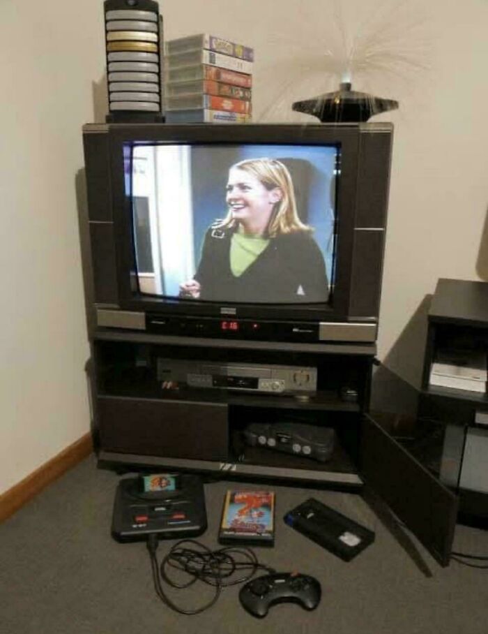 Retro '90s living room setup with CRT TV, VHS tapes, and vintage gaming console.