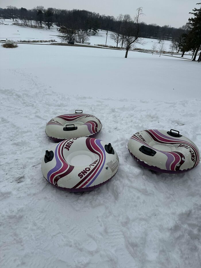 Three colorful snow tubes lie on a snowy hill, ready for winter fun, embodying a Buy It For Life purchase.