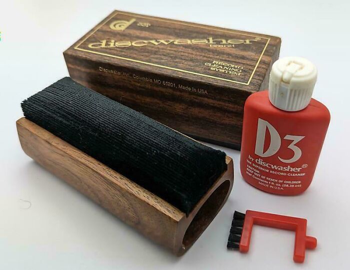 Vintage Discwasher kit with brush and vinyl record cleaner, showcasing nostalgia.