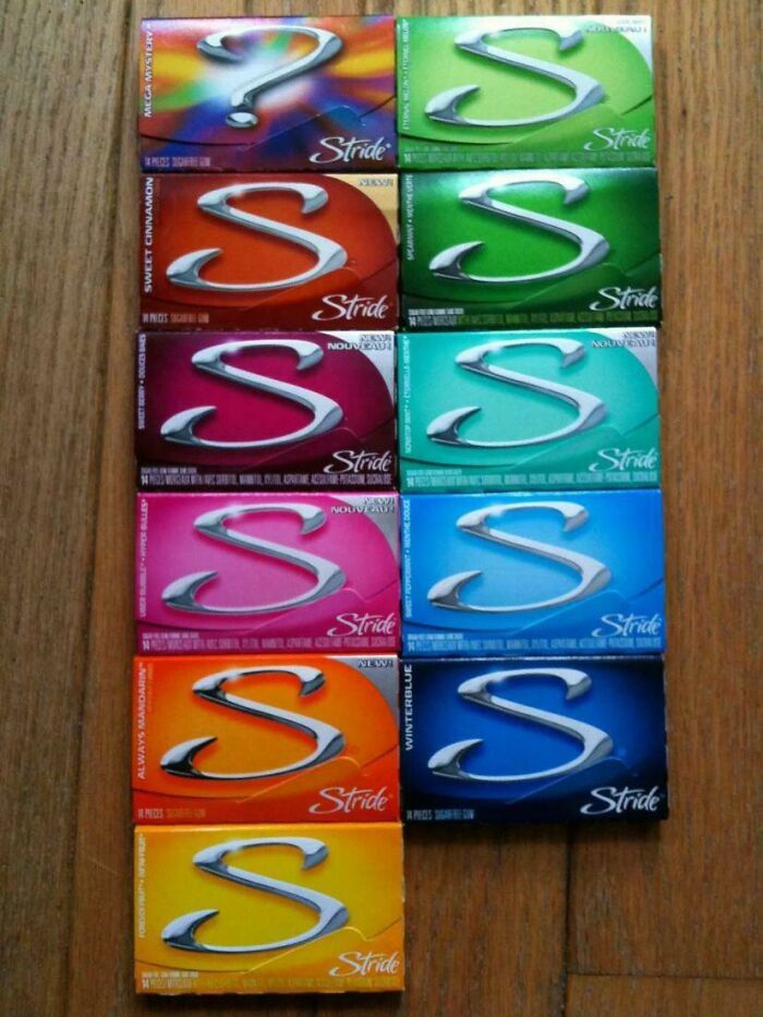 Various Stride gum packs from the 2000s arranged on a wooden surface.
