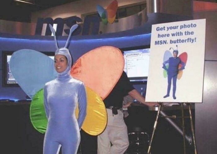 Person in a colorful butterfly costume at an MSN booth, capturing a nostalgic moment from the 2000s.