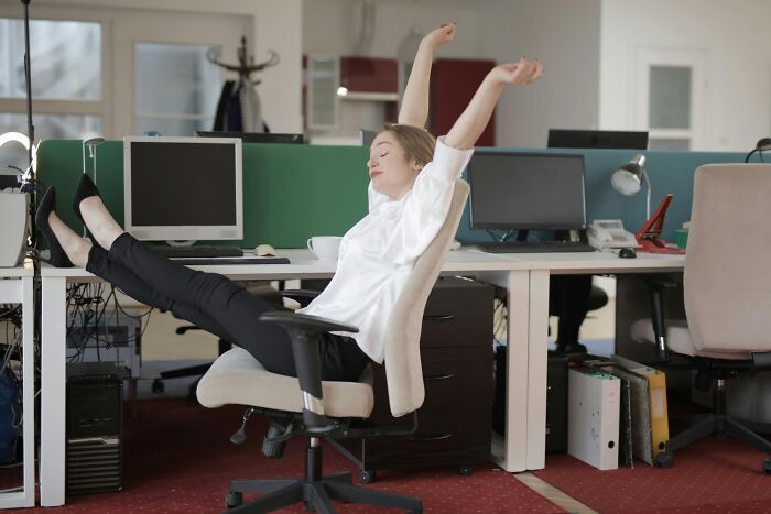 Person relaxing in an office chair, demonstrating Brilliant-Life-Hacks for stress relief at work.