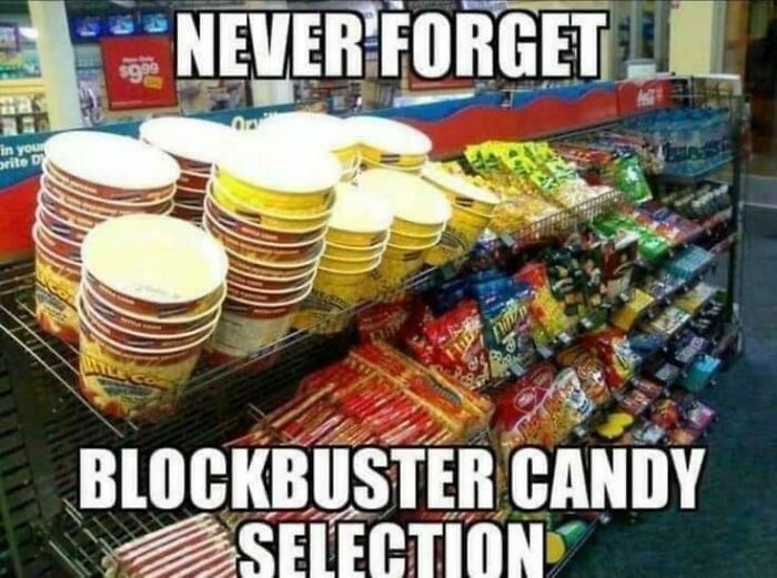 Blockbuster candy selection from the 2000s, featuring popcorn tubs and various snacks on display.
