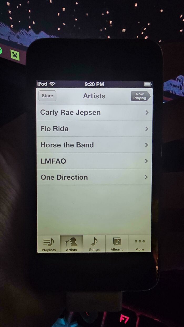 iPod displaying 2000s music artists like Carly Rae Jepsen, Flo Rida, and LMFAO in a nostalgic setting.