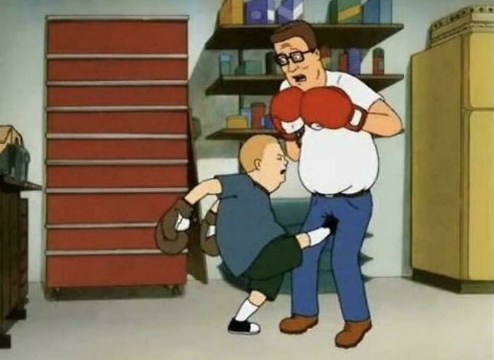 Two cartoon characters boxing in a garage setting, capturing a humorous moment from the 2000s era.
