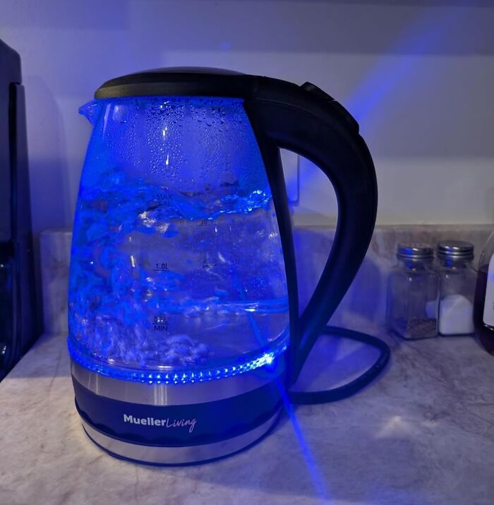 Electric kettle glowing blue, a long-term worthwhile investment on a kitchen counter.