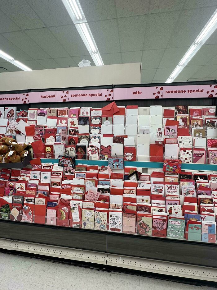 Valentine's Day cards displayed in a store aisle with labeled sections for husband, wife, and someone special.