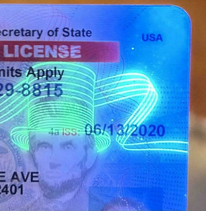 Close-up of a driver license hologram showing Lincoln wearing a glowing neon hat, an interesting shared visual detail.