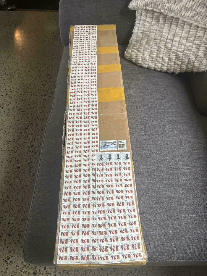 Long cardboard box fully covered with many postage stamps, an example of something moderately interesting shared online.