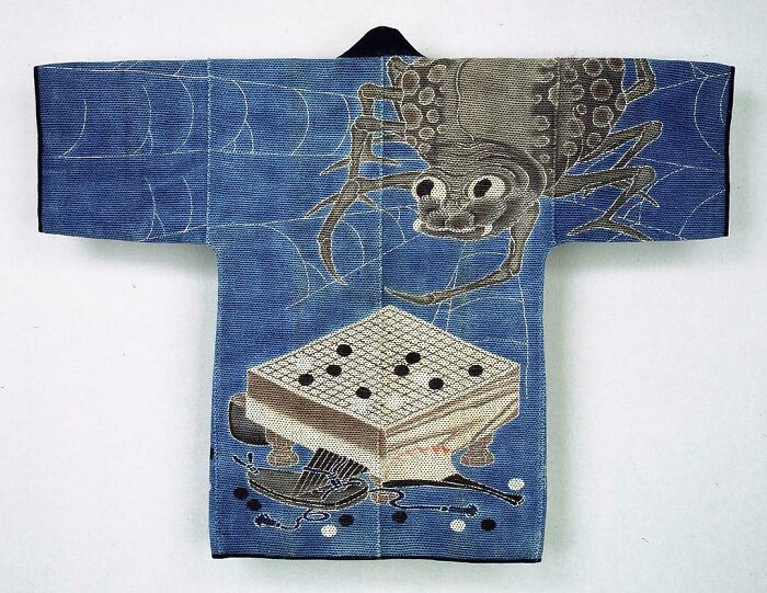 Ancient artefact: kimono with spider and game board design, preserved in great condition.