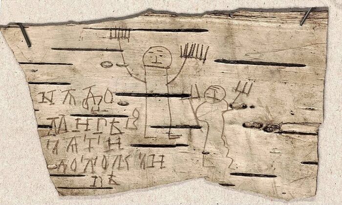 Ancient artefact with carved figures and symbols on a wooden piece, showcasing historical preservation.