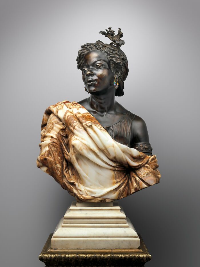Ancient artefact bust with intricate details and classical dress, showcasing artistry that survived through history.