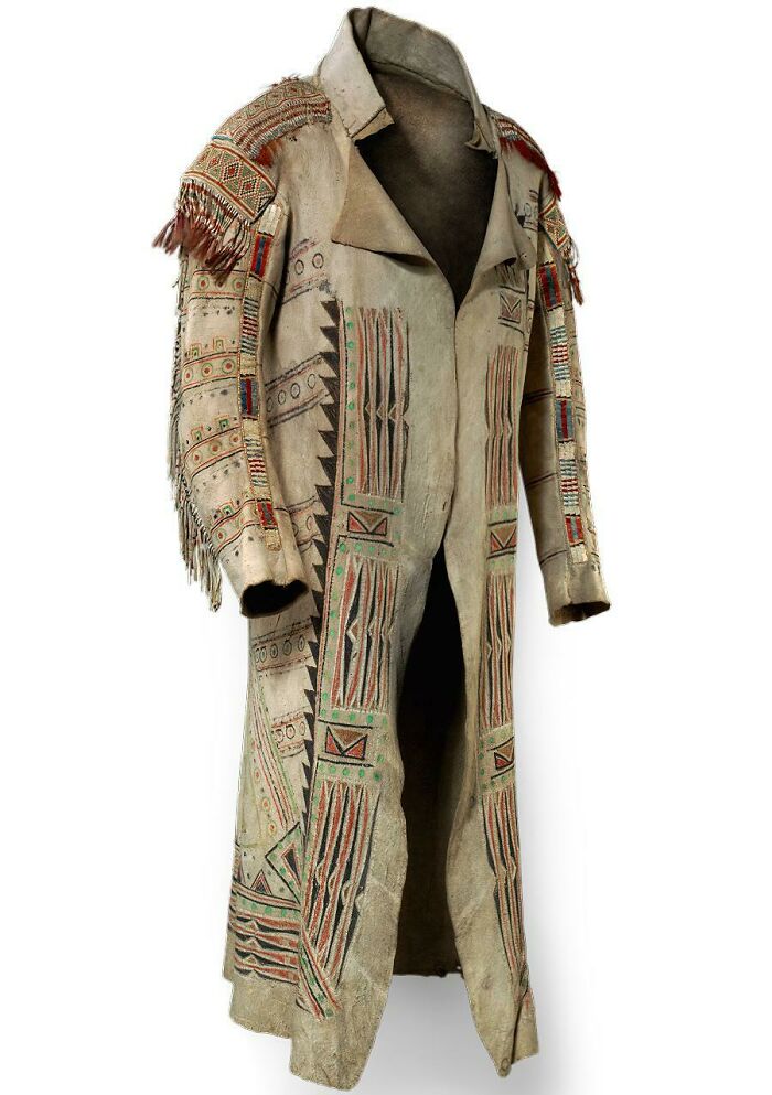 Ancient artefact: intricately designed native tribal coat with detailed patterns and fringe accents.