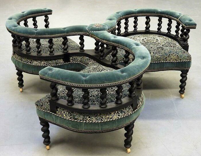Ancient artefact: intricate vintage green velvet loveseat with ornate patterns.