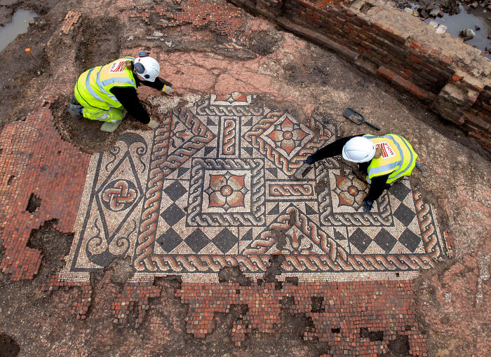 Archaeologists restore ancient mosaic artefact, revealing intricate geometric patterns.