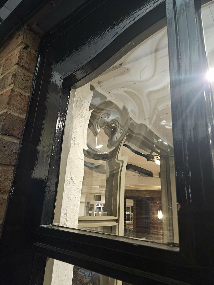 Weird distorted window reflection on a glass pane, creating a unique visual effect.