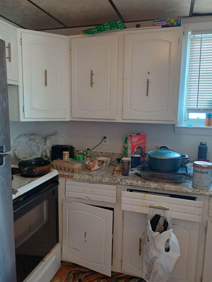 Cluttered kitchen counter with dirty dishes, frying pan, and cereal box, a common frustration with annoying boyfriends or husbands.