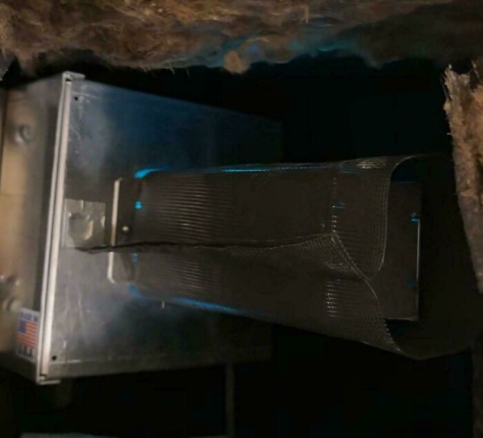 Unusual metal object with duct-like structure, possibly a ventilation system or unknown machinery component.