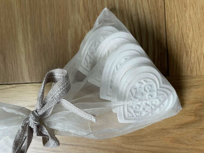 Mesh bag containing heart-shaped items with intricate designs, a weird object found by someone.