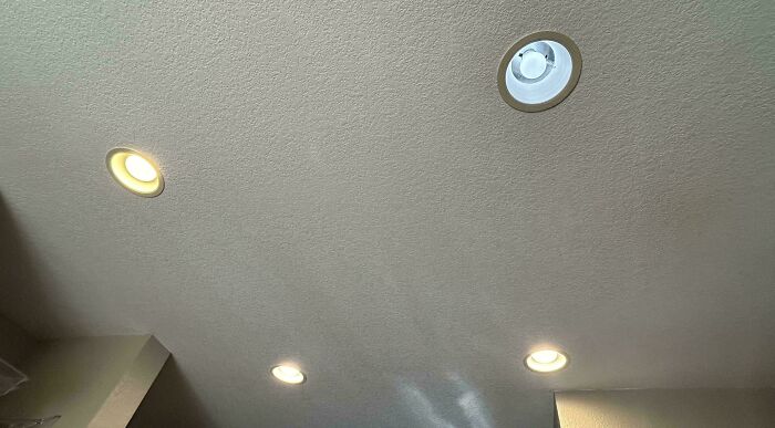 Ceiling with mismatched light bulbs, possibly indicating an annoying habit by boyfriends or husbands.