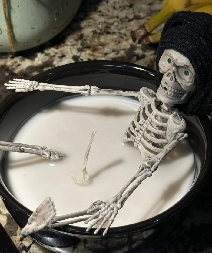 DIY project featuring a small skeleton in a bowl of milk, highlighting craft shaming for odd creations.