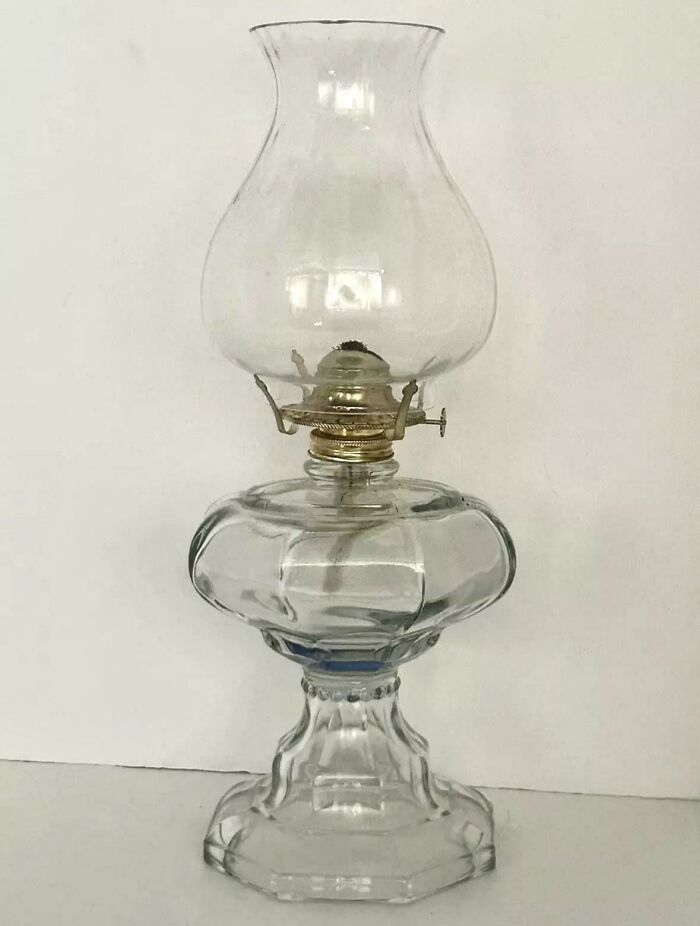 Vintage kerosene lamp with a glass chimney, evoking nostalgia.