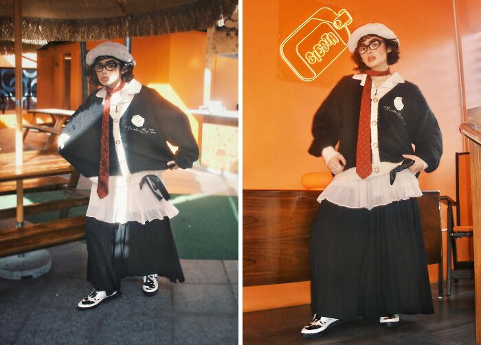 Person nailing fashion risks in layered outfit, beret, red tie, and glasses.