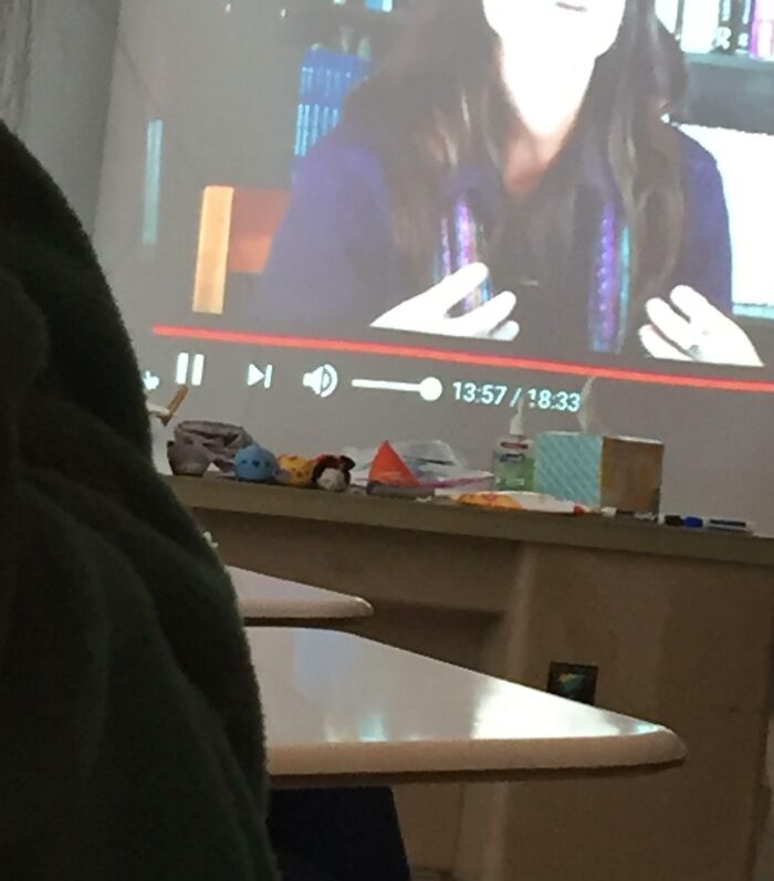 Classroom projector with paused video on teacher, representing bad-infuriating-teachers.
