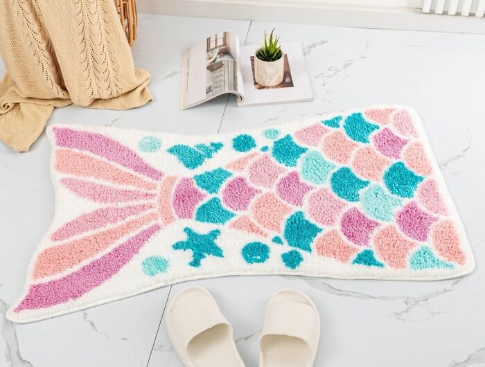 Colorful mermaid tail bathroom mat on marble floor with slippers and decor, enhancing bathroom mats for style and comfort.