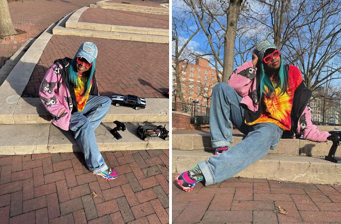 Person taking fashion risks, wearing colorful attire with tie-dye shirt, pink jacket, and vibrant shoes, sitting on steps outdoors.