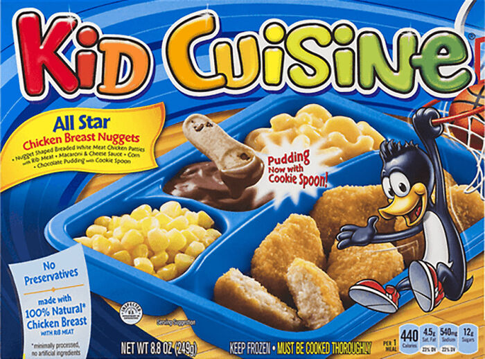 Kid Cuisine meal, featuring chicken nuggets, corn, and dessert, with a fun penguin character, celebrating '90s nostalgia.