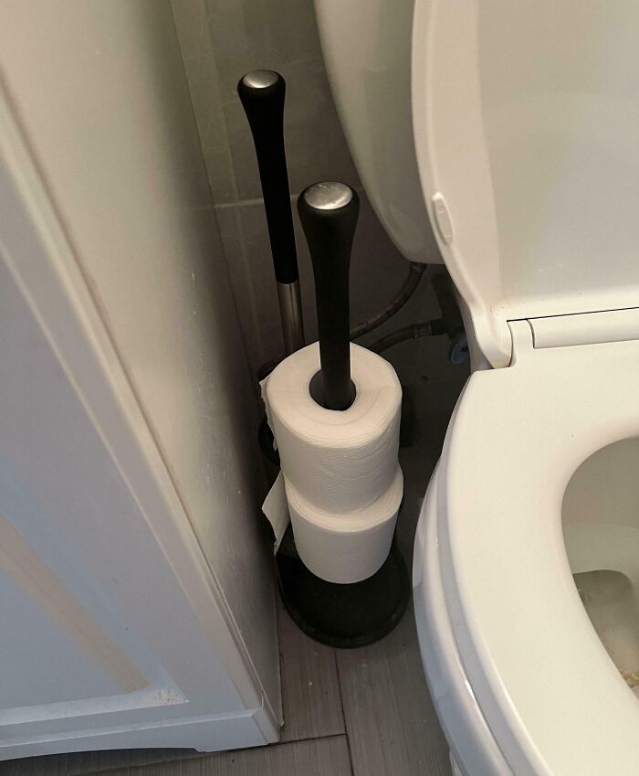 Toilet paper stacked creatively by annoying boyfriends or husbands in a bathroom setting.