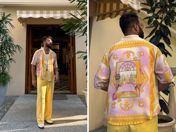 A person confidently poses in a yellow and pastel patterned outfit, showcasing daring fashion risks.