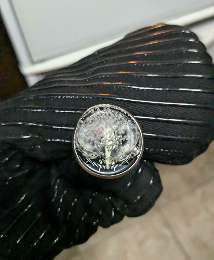 Gloved hand holding a damaged thermostat dial, possibly due to annoying boyfriends or husbands mishandling.