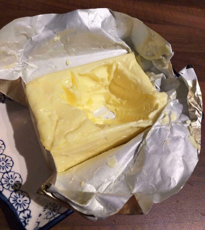 Butter block with a chunk missing, commonly found after annoying boyfriends or husbands use it without cutting properly.