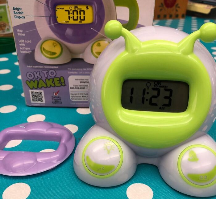 Colorful children's alarm clock on a polka dot table, part of a collection of random things that caught attention.