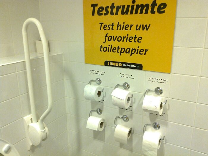 Testing different toilet papers on display for tourist-interesting-experiences in a restroom setting.