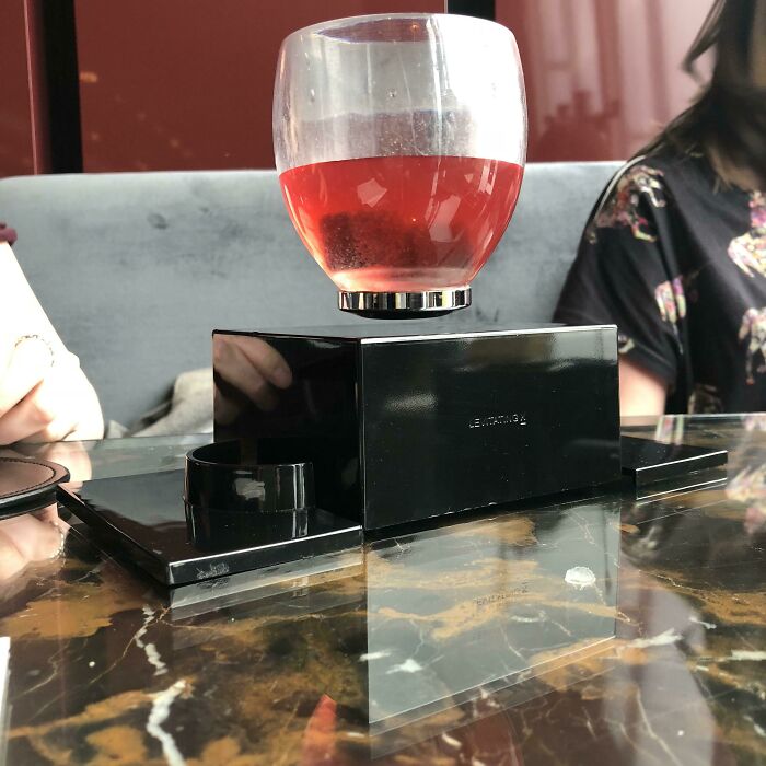 Unique cocktail presentation on a table, providing a tourist with interesting experiences in a chic bar setting.