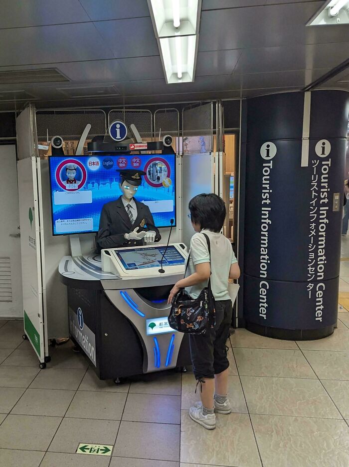 Robot assisting a visitor at a tourist information center, showcasing tourist-interesting-experiences.