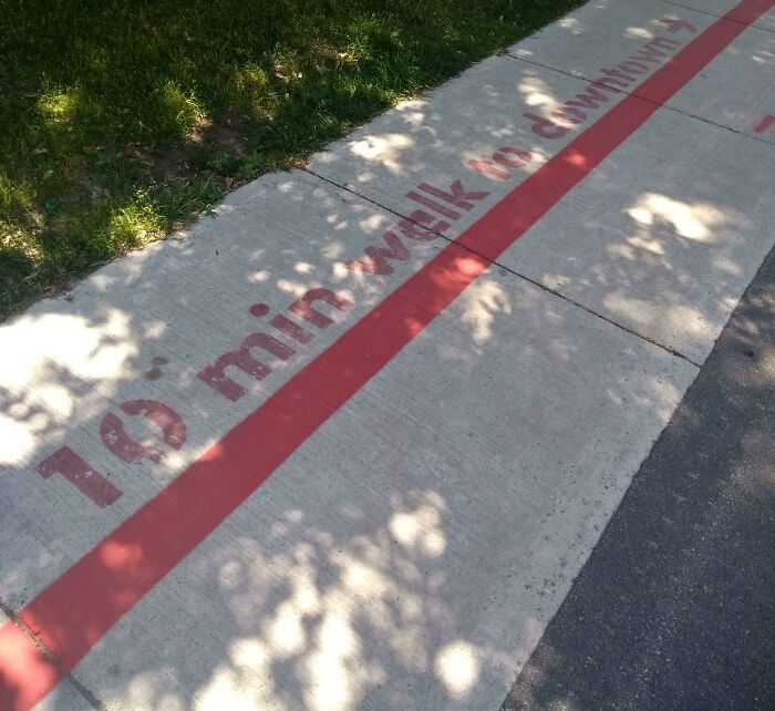 Sidewalk with red line indicating a "10 min walk to downtown," highlighting tourist interesting experiences.
