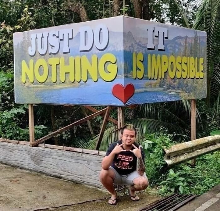 Sign design fail with confusing message, "Just Do Nothing Is Impossible," featuring a person posing below.