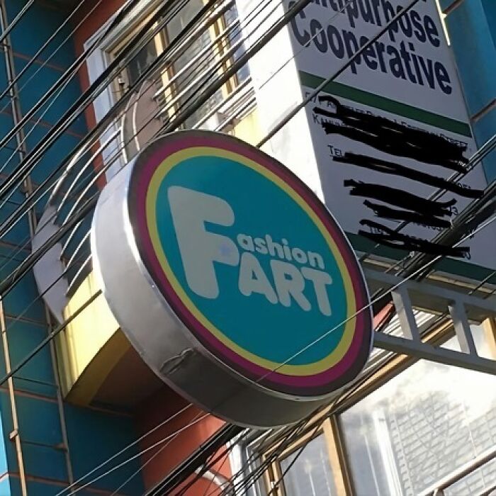 Signage design fail with the text "Fashion Fart" in front of a cooperative building.