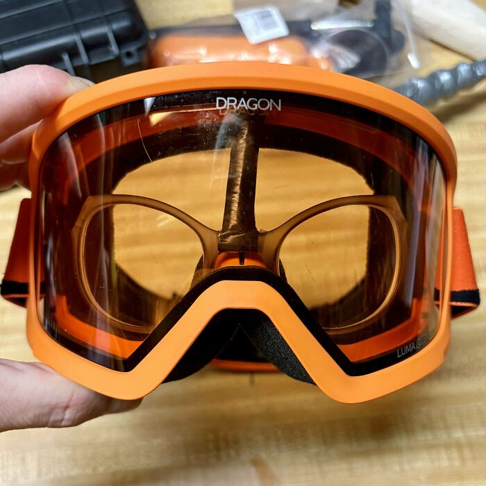 Close-up of orange protective goggles showcasing inventive redneck engineering creativity and practical design solutions.