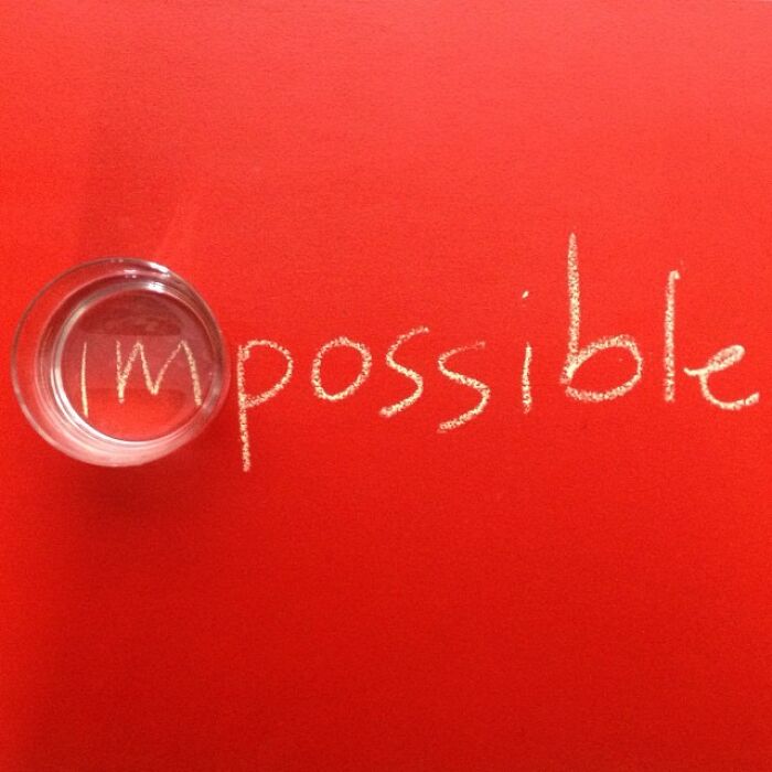 "Jose Ruiz González captures 'impossible' with a glass cup on a red background, creatively altering perspective."