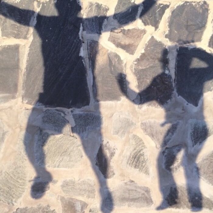 Shadows on a stone pavement captured by Jose Ruiz González, illustrating the extraordinary in the ordinary.