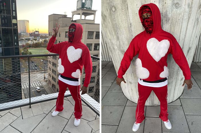 Person taking a fashion risk in a red outfit with white heart patterns and a matching red mask.