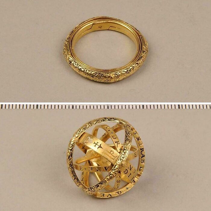 Gold armillary sphere ring, one of 116 ancient artefacts, intricately designed and displayed on a plain background.